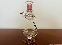 Full side view of glass camel diffuser showing oil reservoir and candle bowl