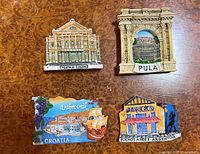 Front view of all four magnets showing designs and colours