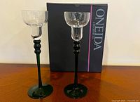 Front view of both crystal glasses beside Oneida box