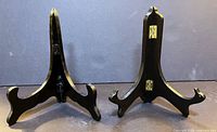 Front view of both black wooden easels standing open