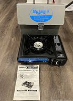 Stove, case open behind, manual displayed