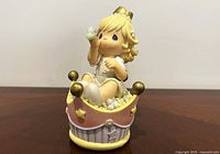 Front view of Precious Moments girl figurine bank