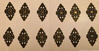 All 12 bronze-tone metal decorations arranged in rows