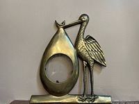 front view of brass stork picture frame