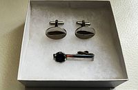 Cufflinks and tie bar clip in presentation box, front view