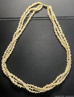 Full view of triple-strand faux pearl necklace