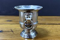 front view of silver plated miniature wine cooler showing lion head ring handle detail