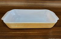 Top view of rectangular peach luster casserole dish highlighting interior and overall size