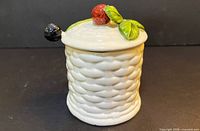 front view of porcelain jar with lid showing 3-D strawberry and leaf