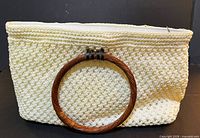 front view showing crochet pattern and wood handle