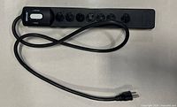 Full view of Woods 7-outlet surge protector with coiled cord