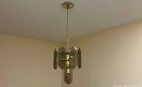 Chandelier hanging from ceiling showing full length with chain and canopy