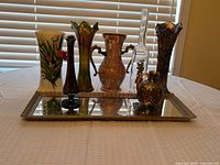 All eight pieces on display including vases, bottles and tray