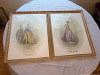 Both framed fashion plate prints side by side