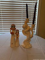 Cherub candelabra, pair of girl figurines, taper candles on table