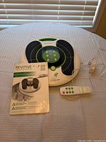 Revitive IX device, manual, remote, power cord displayed on surface