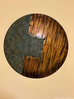 Front view of round metal wall art showing full design