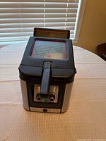 Front angled view of deep fryer showing lid and handle
