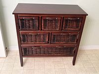 Front view of wood chest showing six wicker drawers