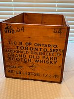 Side view showing stencilled markings L.C.B. of Ontario Toronto and weight