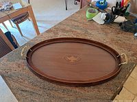 Full top view of wooden oval tray on countertop