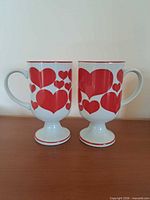 pair of red heart pedestal mugs