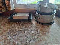 Group shot showing cooling rack, rectangular pan stack, and round pans