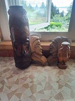 Group shot of all four wood carvings on countertop