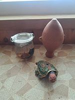 All three items grouped: cloisonné turtle, Weck oil candle jar, terracotta vase
