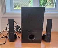 Full speaker set showing subwoofer center and two satellites