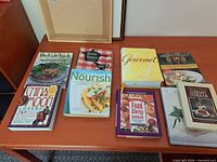 Overview of all nine cookbooks on table