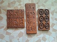 Three terracotta plaques side by side