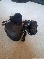 Camera with case and strap visible