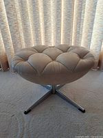 Angled view showing full ottoman and pedestal base