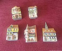 Front view of five Michel Dupuy ceramic buildings
