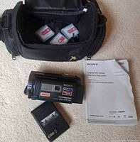 Camcorder, carrying case with memory cards, battery, manuals