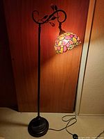 Full view of lamp lit showing overall height, base, cord and foot switch