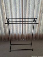 Full view of black metal freestanding towel rack