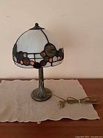 Full view of stained glass lamp on table