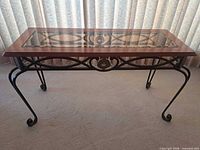 Full view of the glass-top wood and wrought iron console table