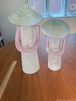 Both glass sculptures front view with ruler for scale