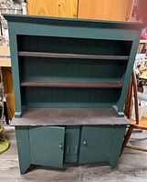 Full view of green painted wooden hutch cabinet