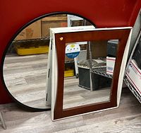 Both mirrors leaning against wall showing overall design
