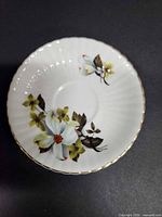 saucer top view showing floral pattern and gold trim