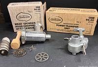 Both Sunbeam boxes with grinder parts and power transfer unit displayed