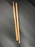 Full view of both natural wood drumsticks