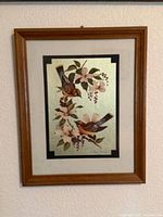 Full view of framed bird print in wooden frame