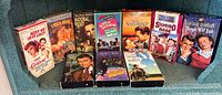 Group shot of all ten VHS tapes standing upright