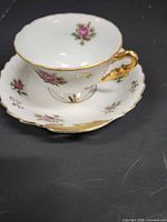 teacup on saucer angled view showing pattern and gold trim