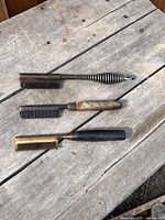 Three hot combs laid out showing full forms
